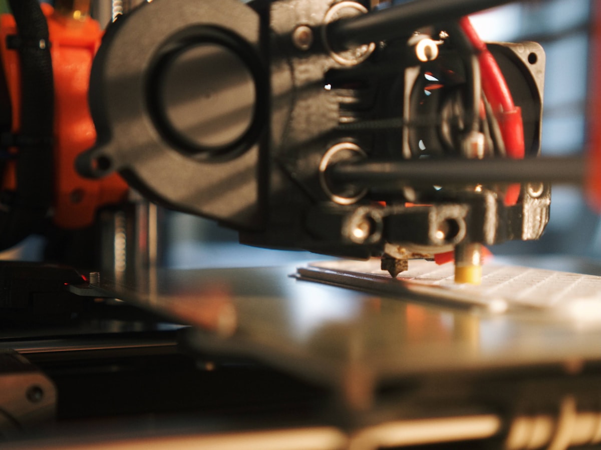 3D printer printing a part in a maker workshop